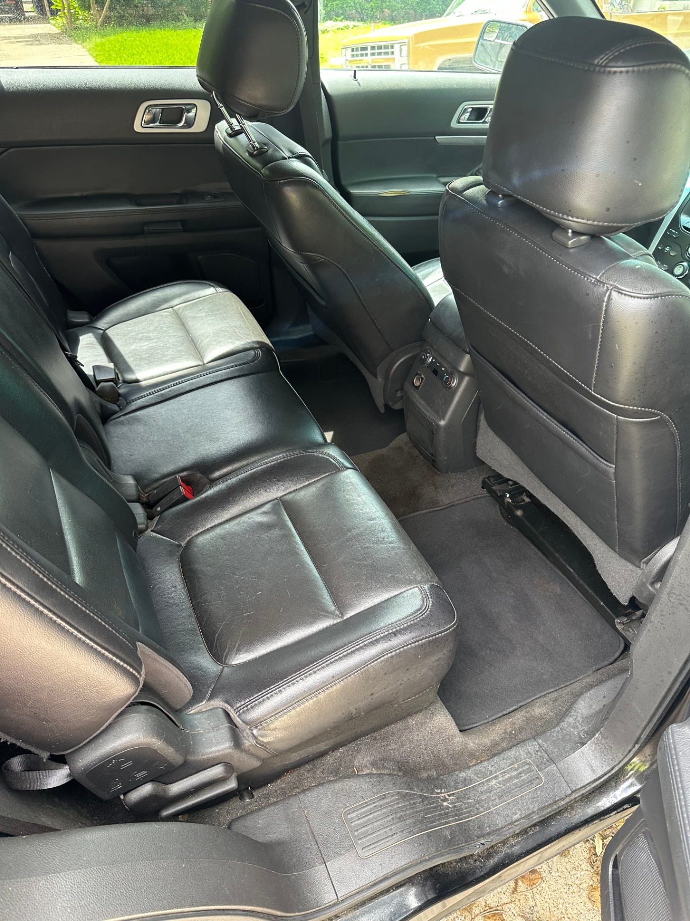 Dirty leather rear seats before a Bliss Performance Detailing interior reset